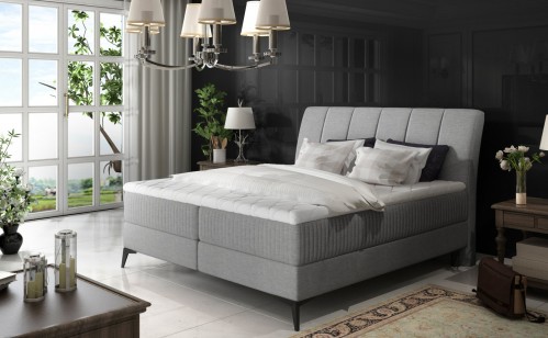 Oblazinjena boxspring postelja Aderito z dvojnim shranjevanjem