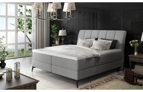 Oblazinjena boxspring postelja Aderito z dvojnim shranjevanjem